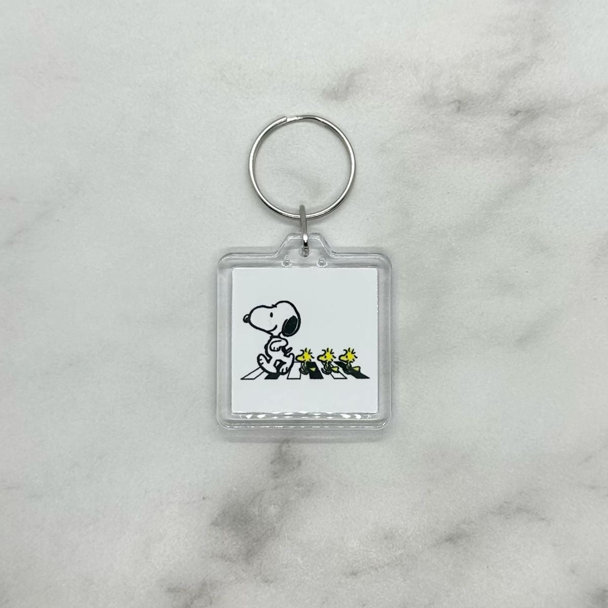 Cute acrylic photo keychain of Snoopy and Woodstock crossing the road like the Beatles Abbey Road.