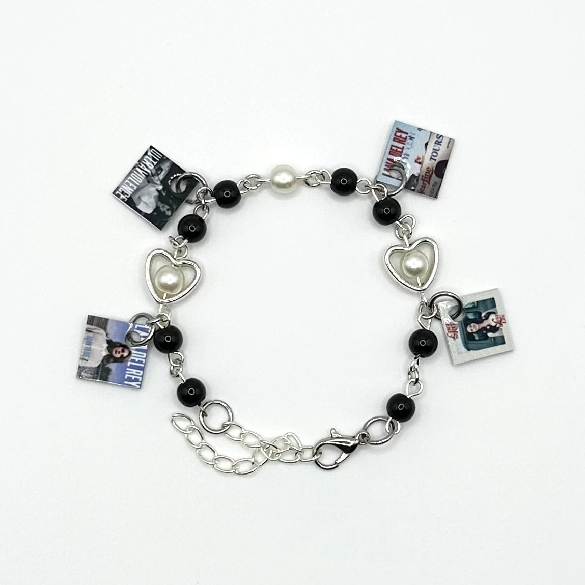 A charm bracelet with miniature (half inch) metal Lana Del Rey albums and lobster claw clasp closure.