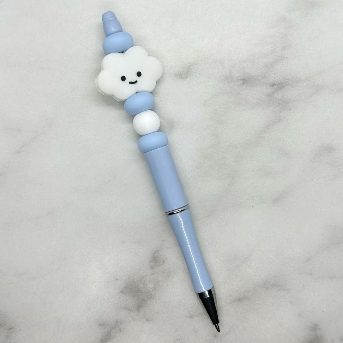 Cute light blue ballpoint pen with white cloud charm. Black ink.