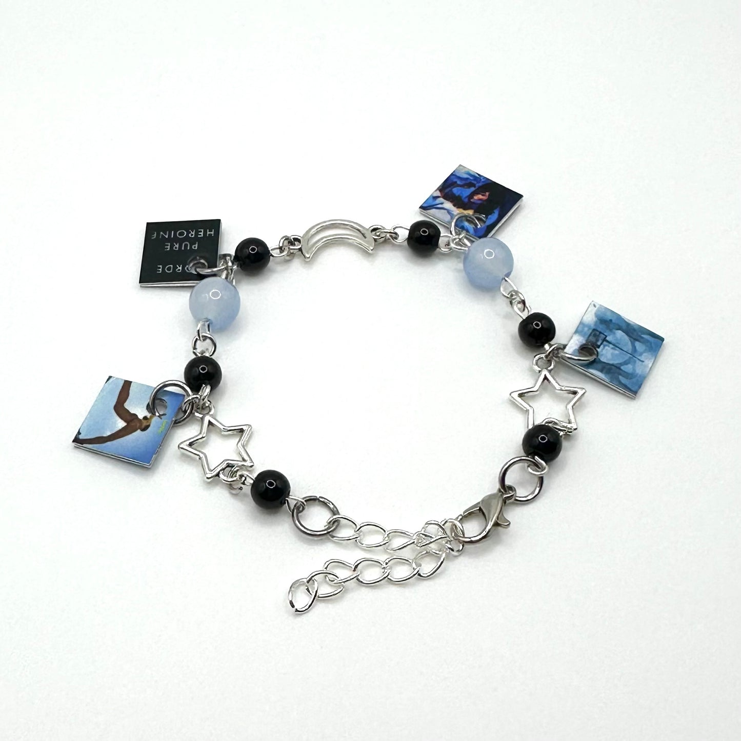 A charm bracelet with miniature (half inch) metal Lorde albums and lobster claw clasp closure.