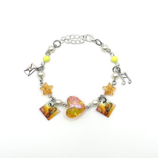 A charm bracelet with miniature (half inch) metal Addison Rae's debut album and lobster claw clasp closure.