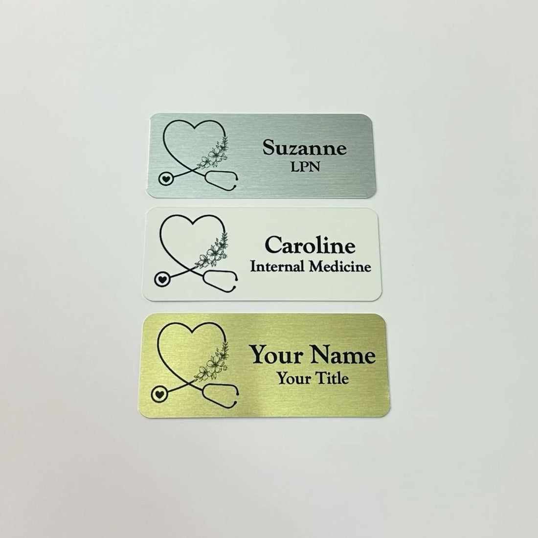 Personalized medical or nurse name tags with stethoscope shaped heart. Multiple colors, sizes, and attachment styles.