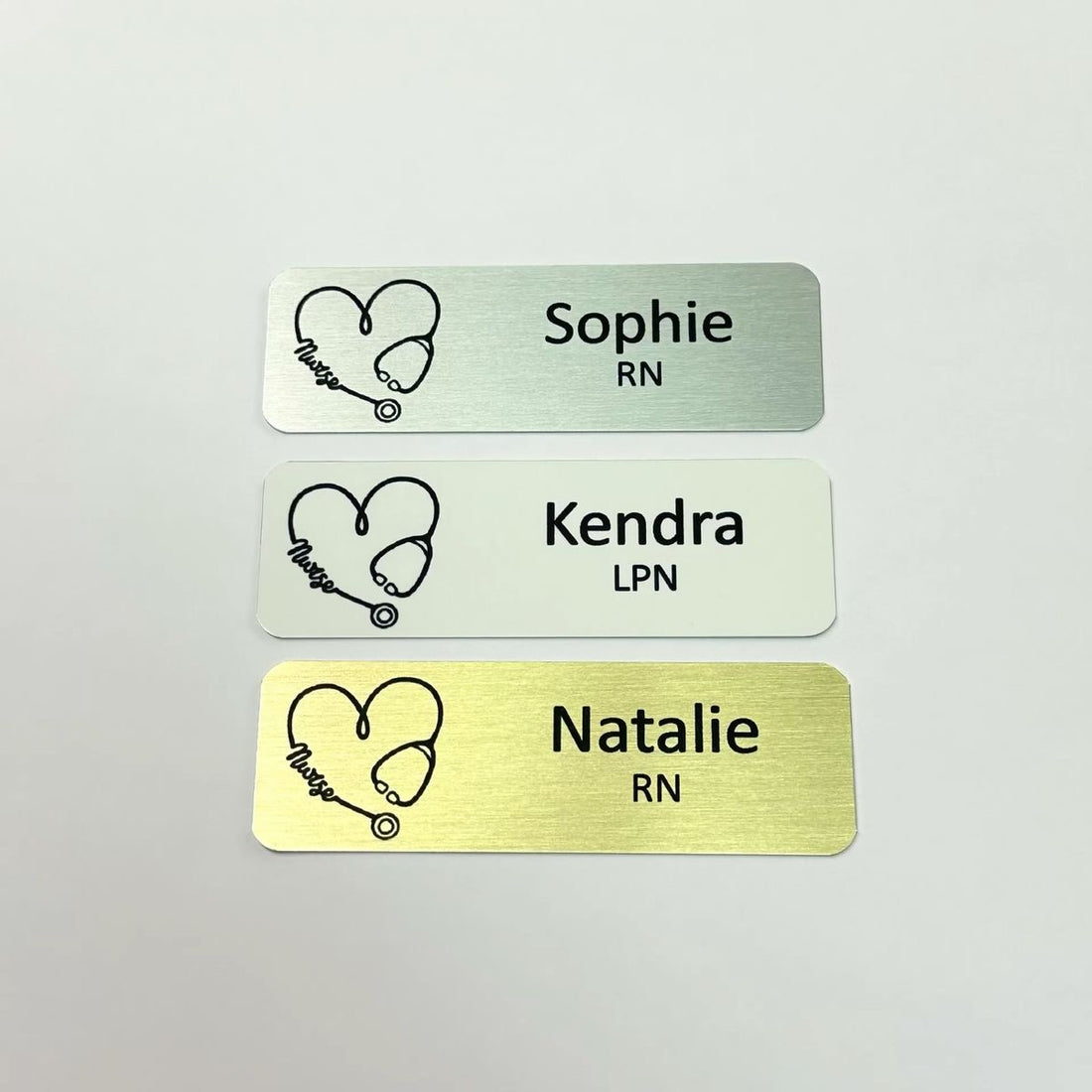 custom personalized gold, silver, or white metal aluminum medical nurse name tags with stethoscope heart. magnet or pin attachment.