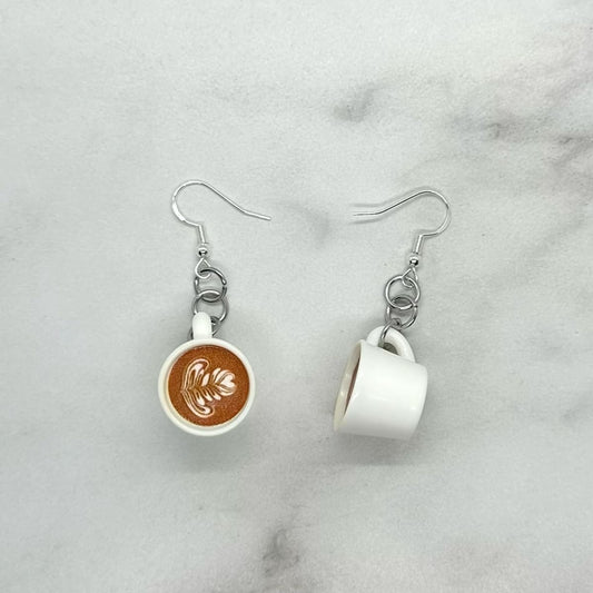 Cute miniature cup of coffee latte earrings. Sterling silver hypoallergenic ear hook closure.