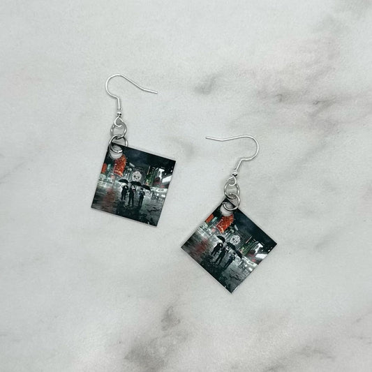 A pair of square earrings with an image of Jonas Brothers album cover A Little Bit Longer, attached to hypoallergenic sterling silver ear wire closure.