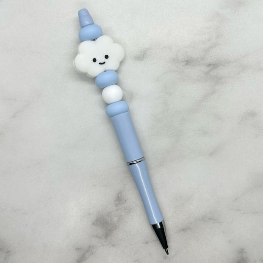 Cute light blue ballpoint pen with white cloud charm. Black ink.