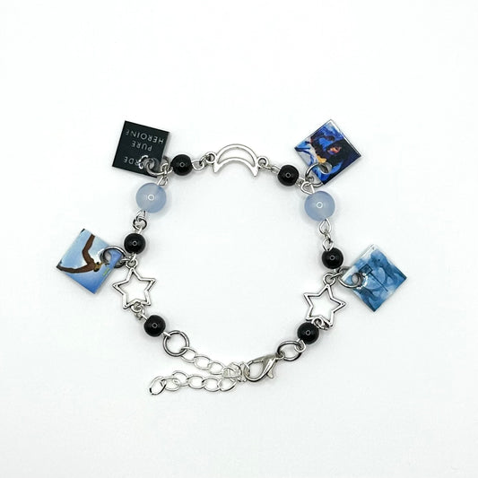 A charm bracelet with miniature (half inch) metal Lorde albums and lobster claw clasp closure.