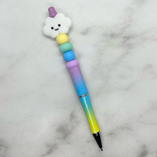 Cute rainbow multicolor ombre green, blue, purple ballpoint pen with white cloud charm. Black ink.