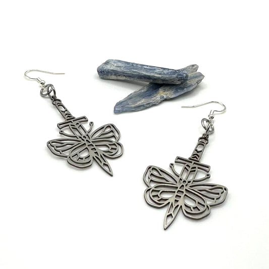 A pair of stainless steel butterfly/moth sword earrings with a hypoallergenic sterling silver ear wire closure.